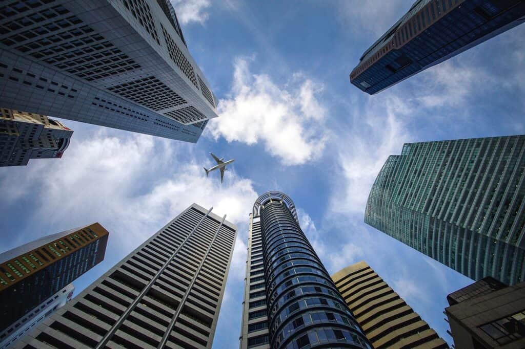 Modern skyscrapers representing LLC vs Singapore Pte Ltd vs Dubai FZE corporate structures
