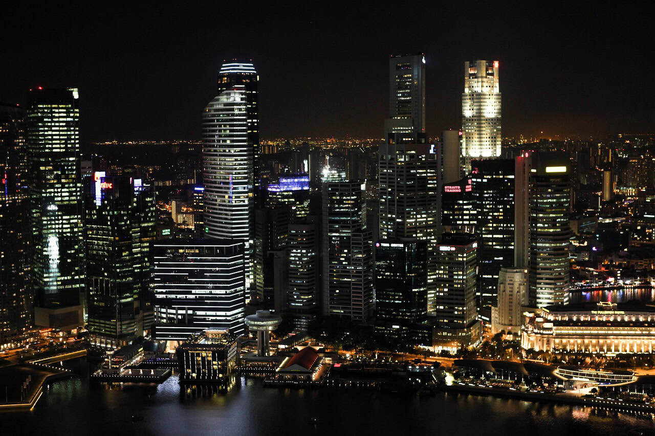 Singapore skyline at night for regional EOR vs local entity hiring analysis