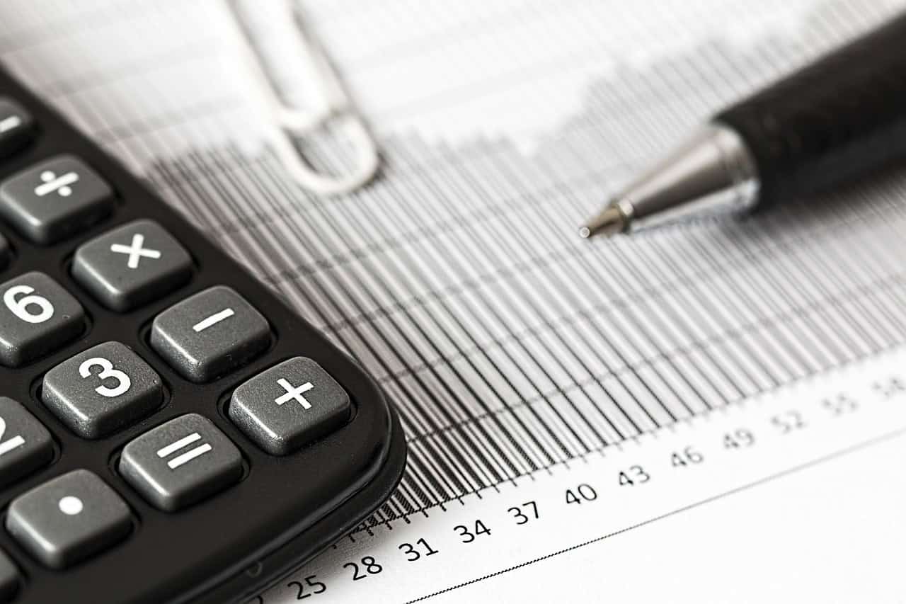 Calculator and pen on financial documents for tax residency day-count calculations