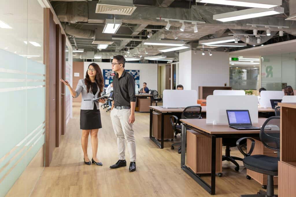 Professionals working in a modern Singapore coworking space for Employment Pass holders