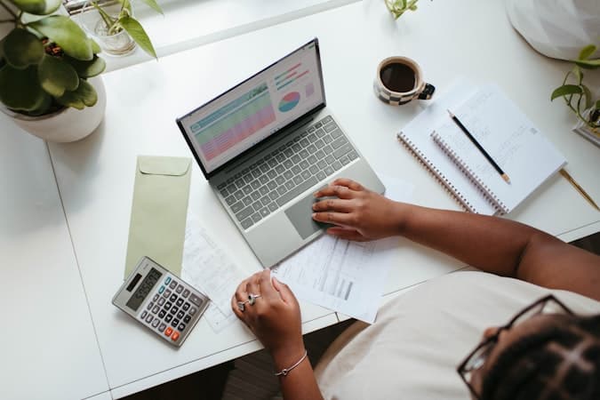 Entrepreneur reviewing international fee structures and currency costs on laptop