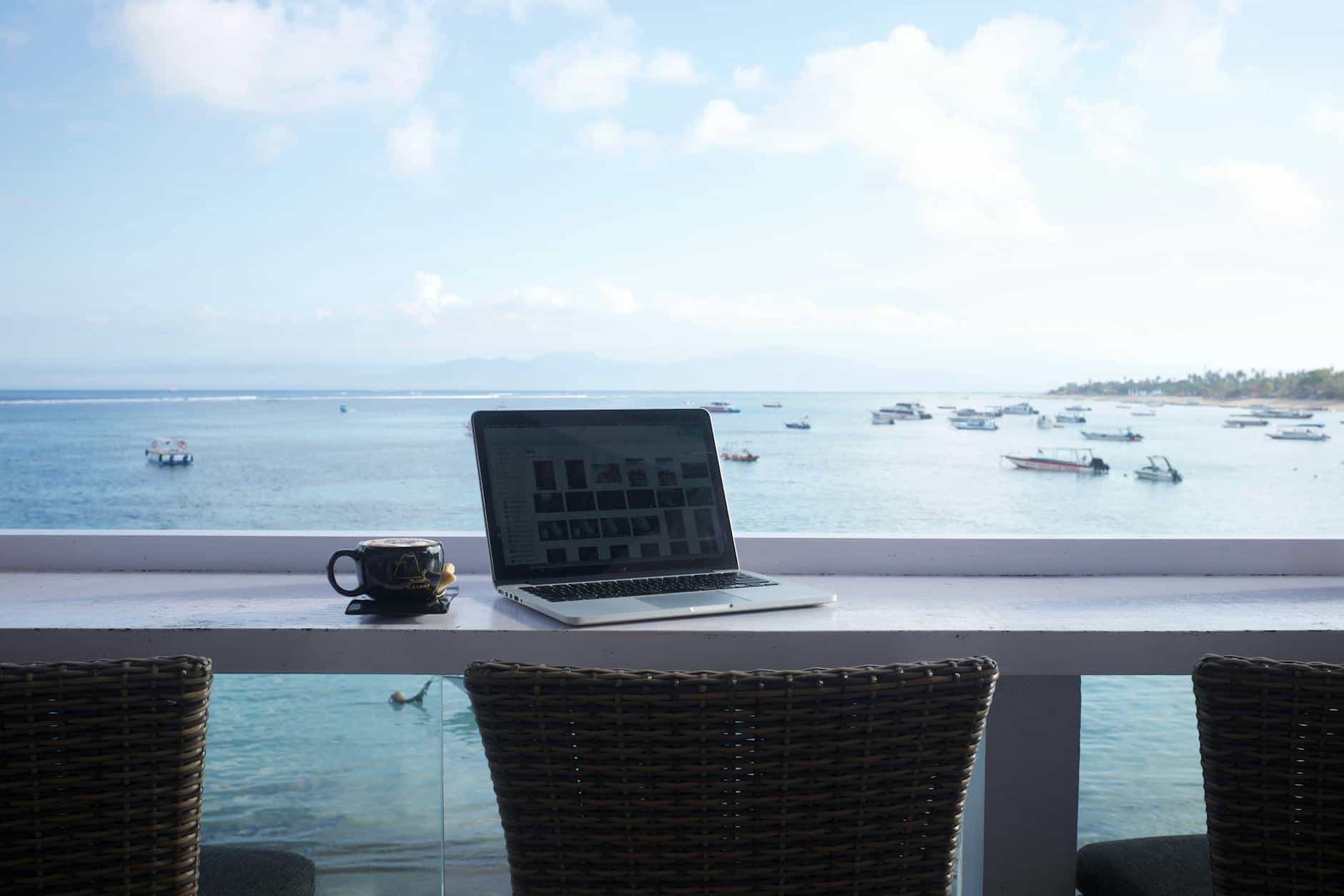 Bali beachside laptop setup ideal for remote workers on Indonesia's KITAS visa