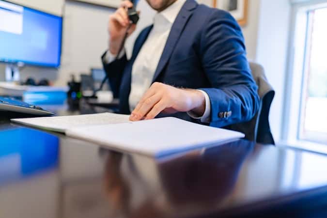 Business owner comparing Wise vs Airwallex Singapore fees and pricing at desk