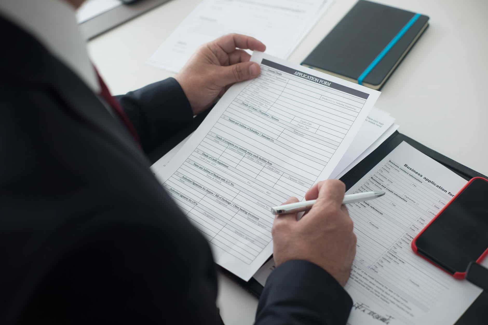 Businessman reviewing application form and timeline for an Employment Pass in Singapore