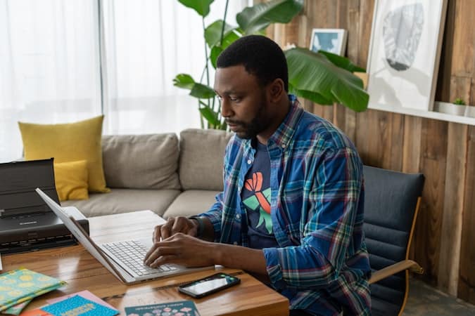 Entrepreneur reviewing key features of multi-currency business accounts on laptop