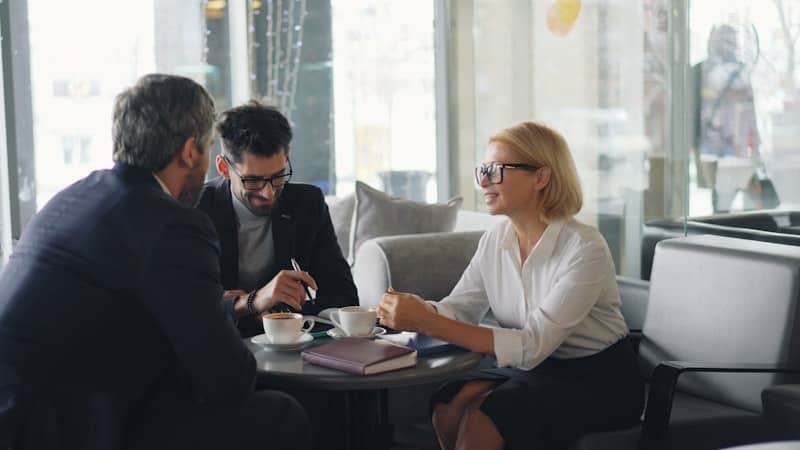 Three professionals discussing alternative financing options available to Hong Kong-based entrepreneurs