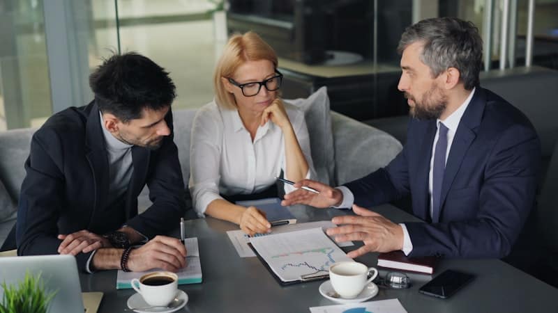 International business team comparing multi-currency account providers at a meeting