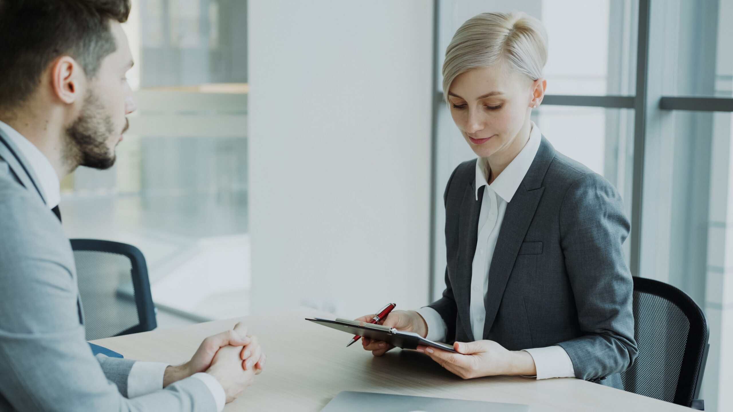 Businesswoman calculating finances to document source of funds for offshore banking