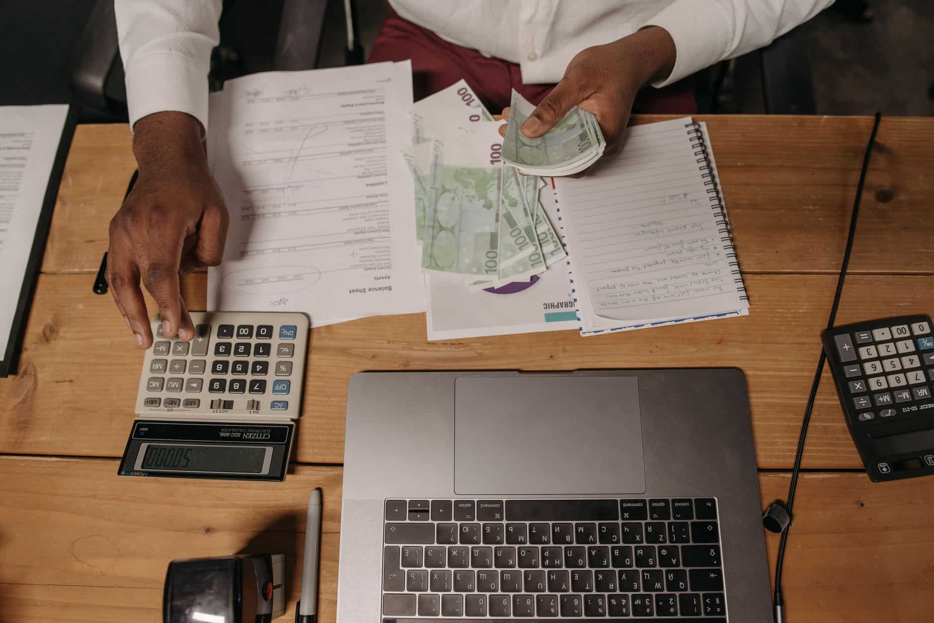 Person counting cash while reviewing documents related to the substantial presence test