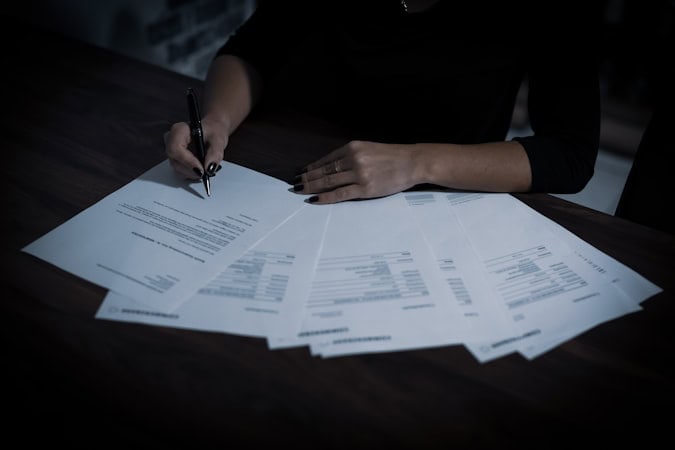 Lady signing KYC documentation as part of offshore company bank compliance requirements