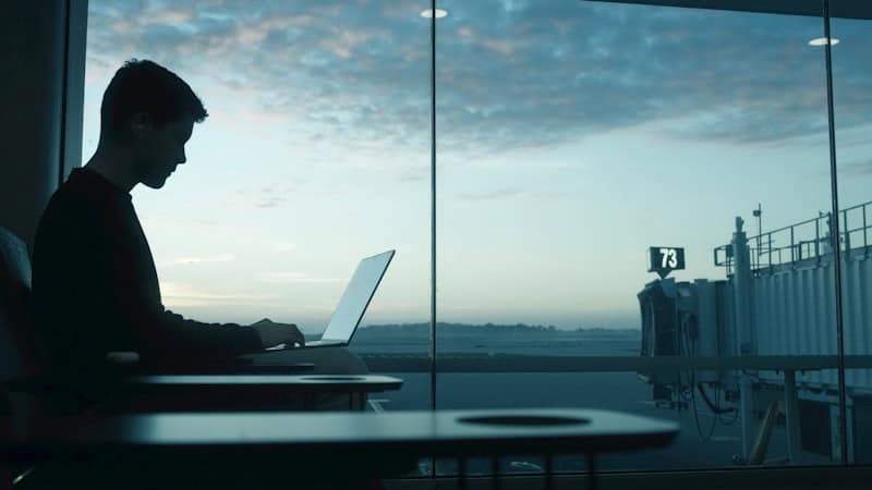 Remote professional working on laptop while traveling across international time zones