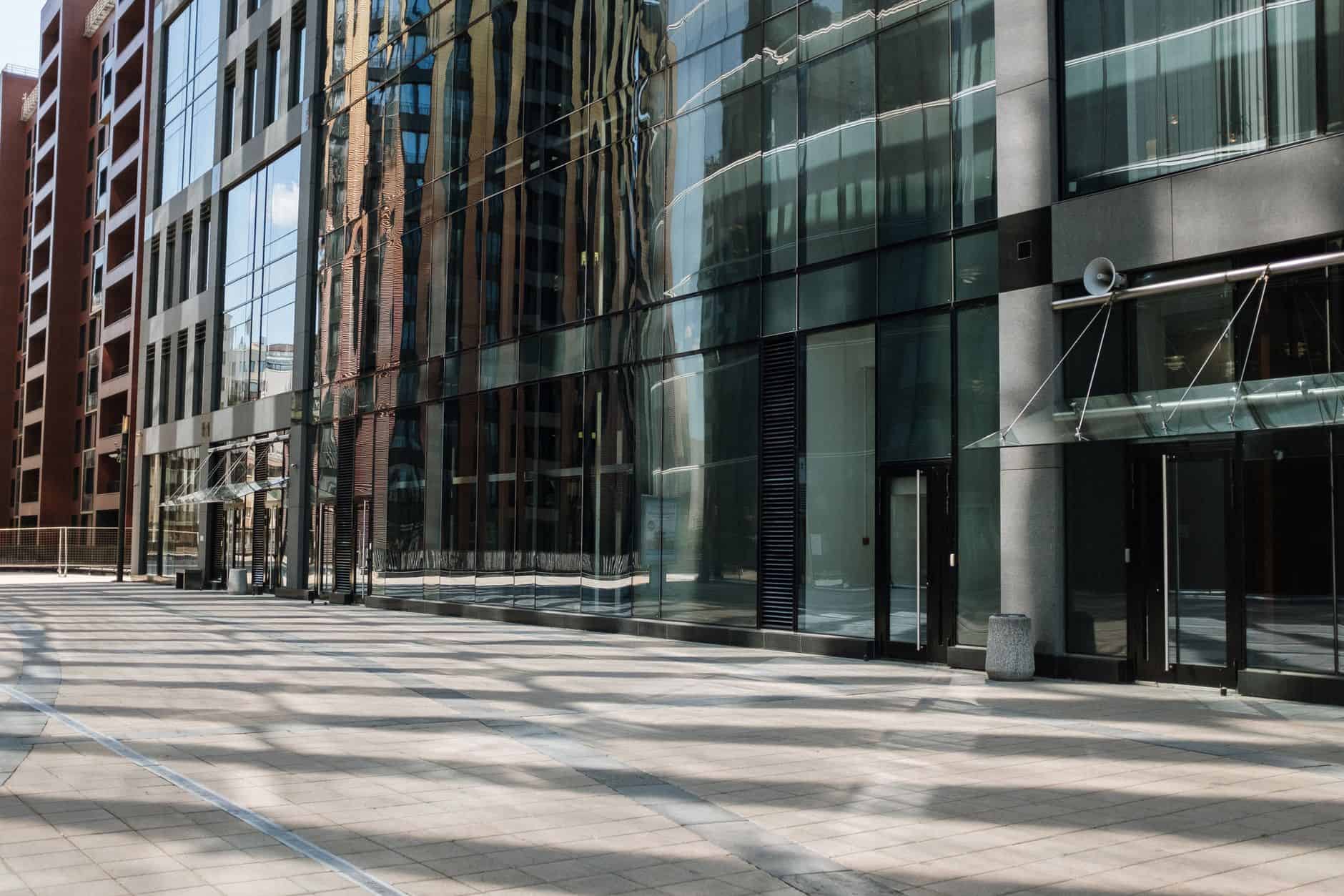 Modern glass cityscape reflecting the global nature of remote compensation models