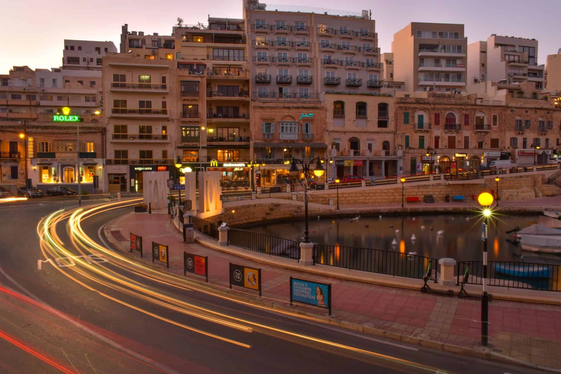 Saint Julian's Bay sunset cityscape illustrating Malta for expats operating cost advantages