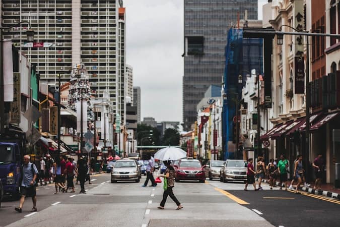 Pedestrians crossing a busy street symbolising post-incorporation compliance steps