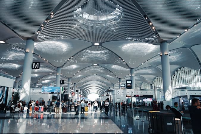 Commuters walking through a busy terminal illustrating how days abroad affect UK residency