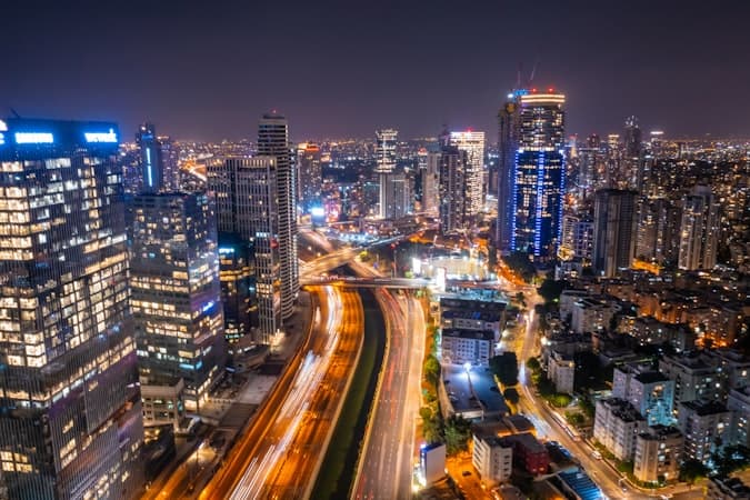 Tel Aviv skyline at night symbolizing global reach of cross-border IBAN transactions