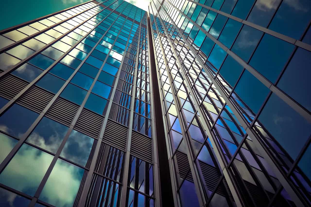Modern glass skyscraper reflecting international capabilities available to global business owners