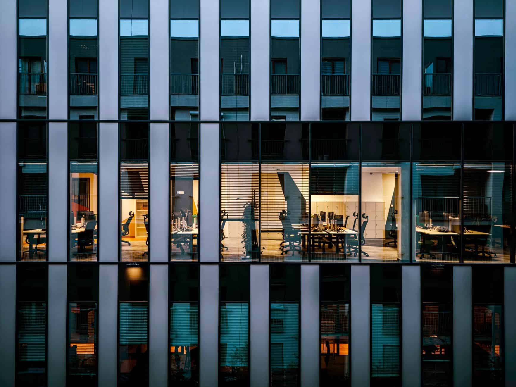 Modern glass office building interior illustrating multi-currency workspace and SWIFT payment operations