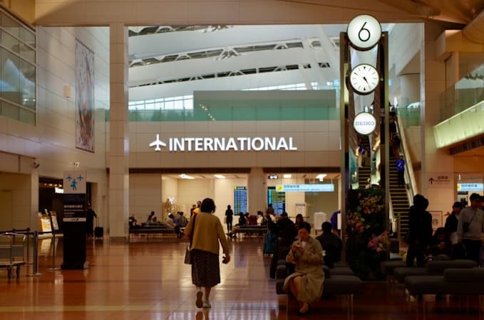 Travelers in airport terminal weighing Cyprus non-dom status against domiciled tax rates