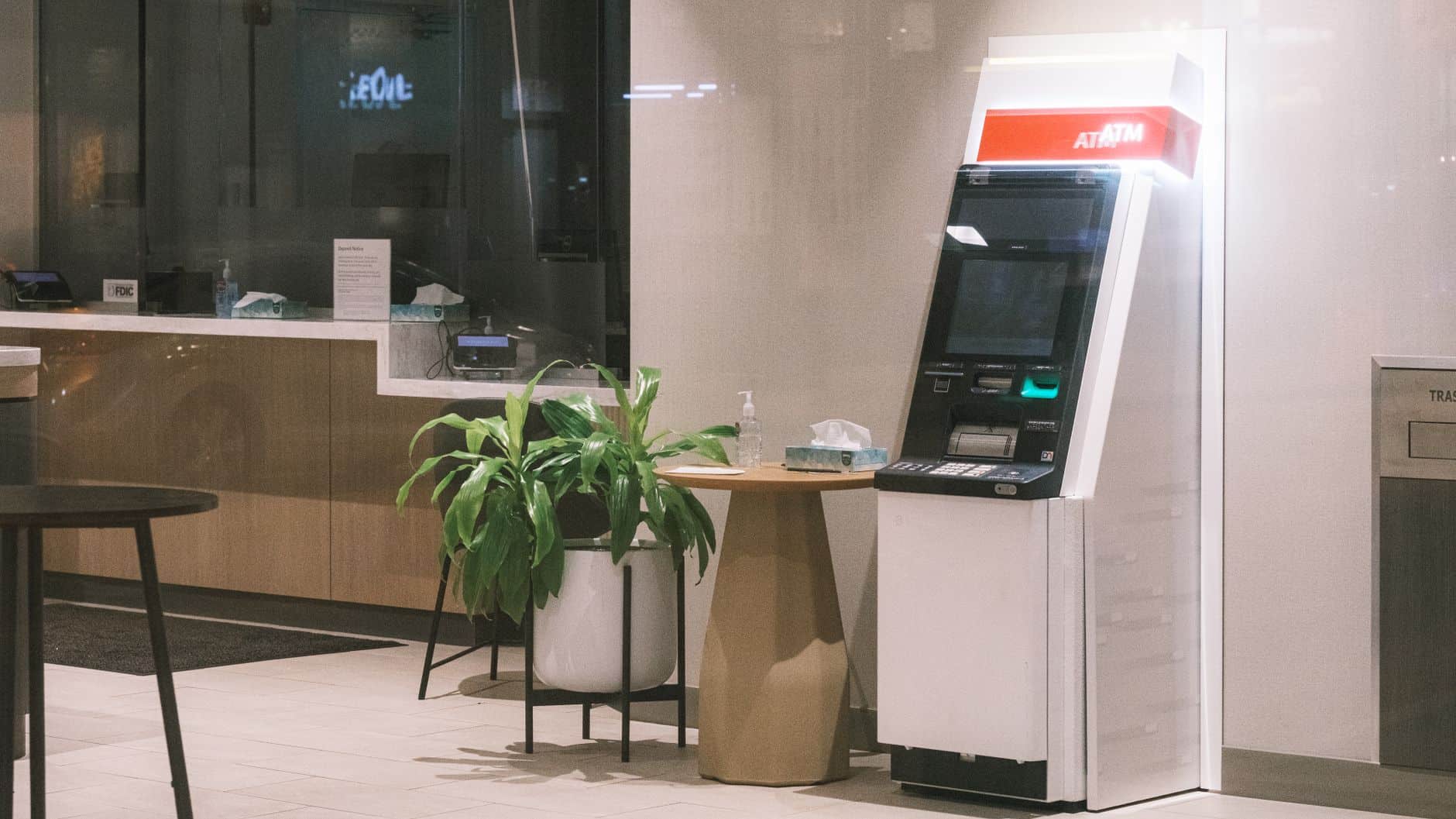ATM in bank lobby illustrating how Revolut compares to Wise for international structures