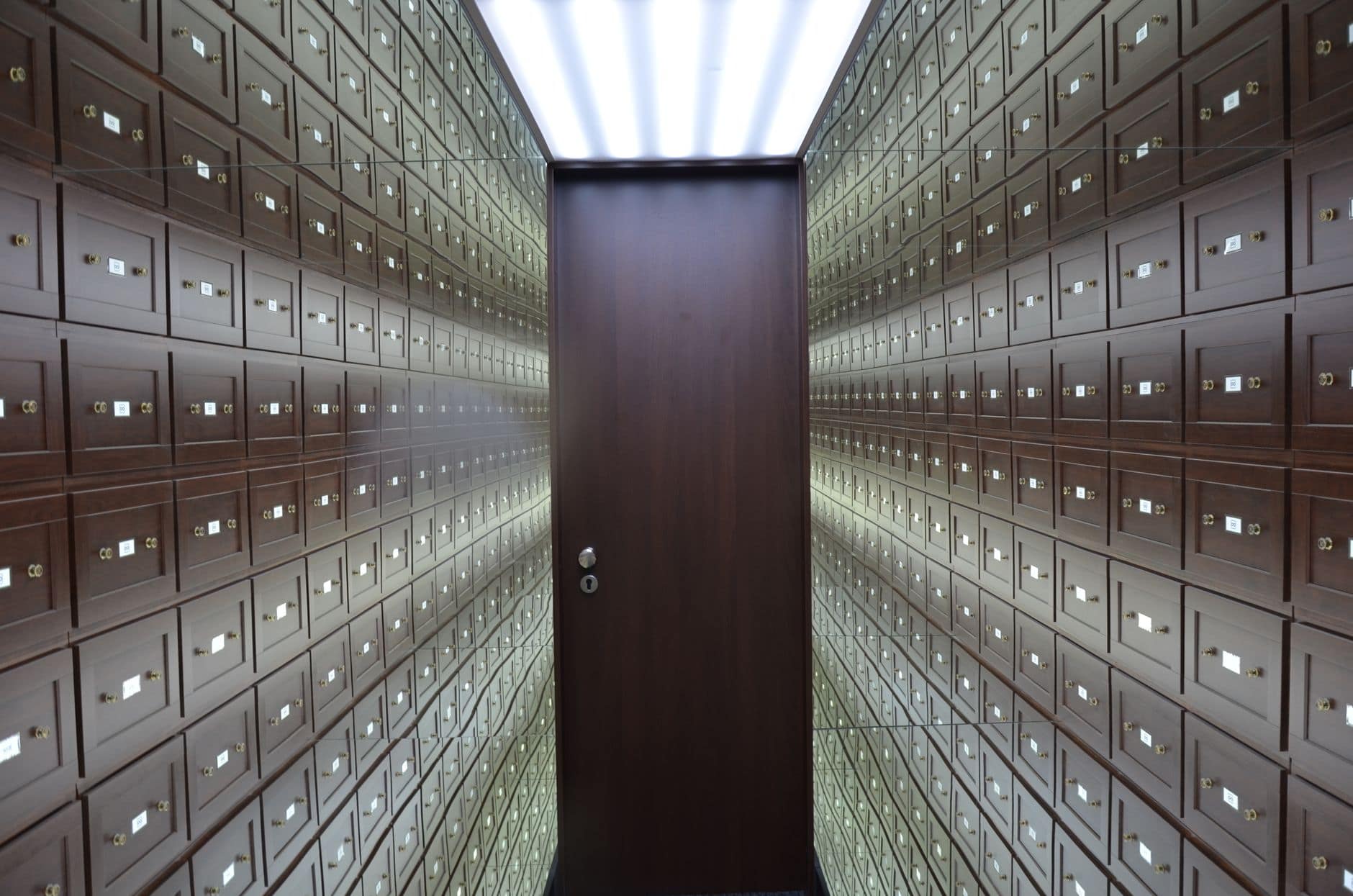 Secure vault with wooden lockboxes representing compliance and risk management in international payments