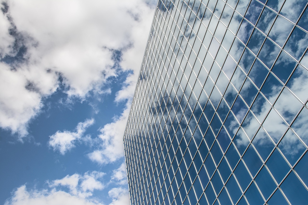 Glass skyscraper facade representing the choice between in-house and outsourced company secretary services