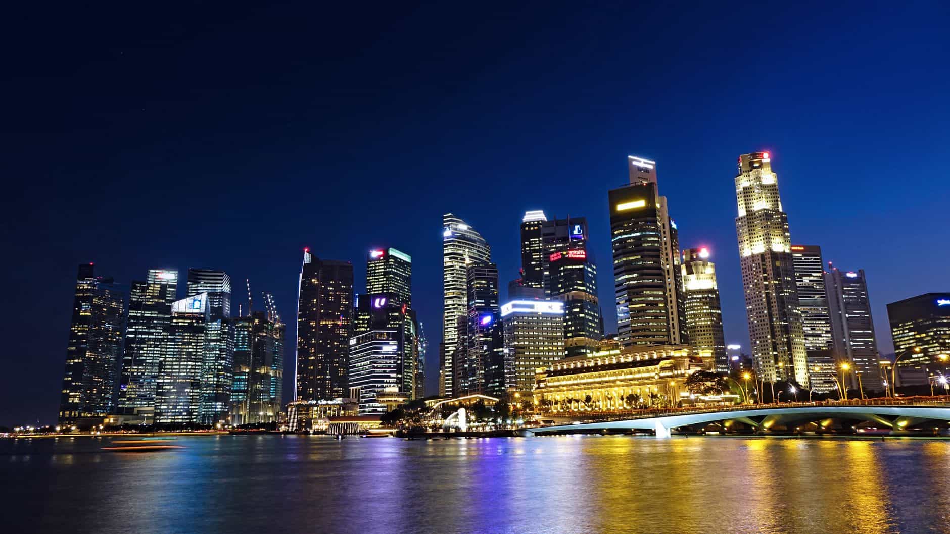 Singapore fund manager tax breaks reflected in the city's glittering financial skyline at night
