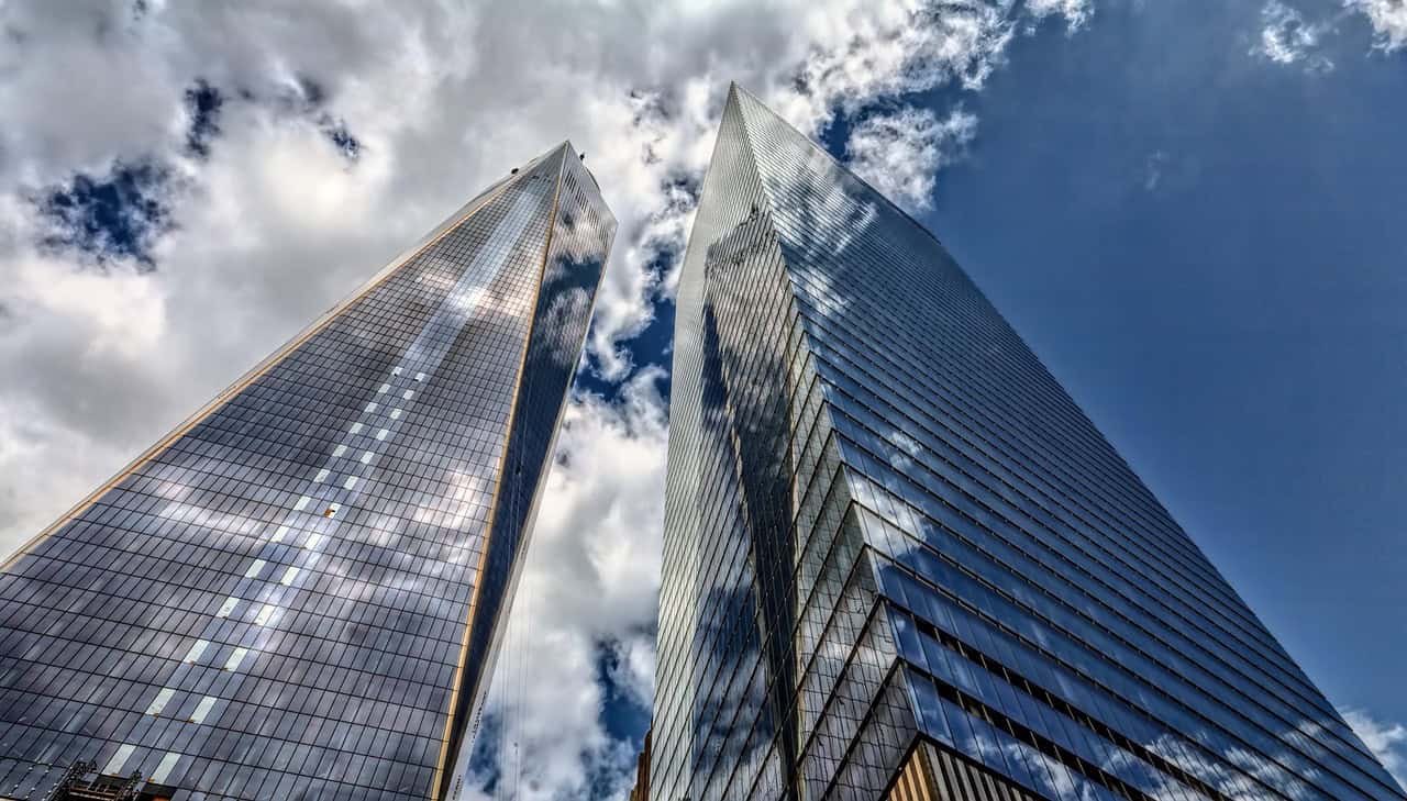 Manhattan skyscrapers symbolizing the global scope of business credit cards international compared across SG, HK, and US