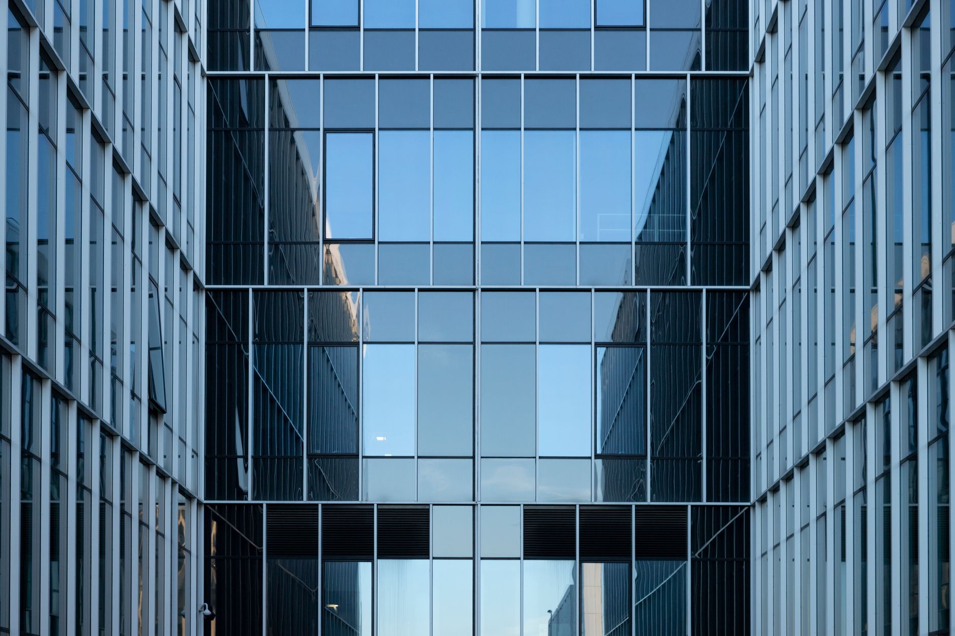Reflective glass office facade representing a BEPS-compliant holding company headquarters