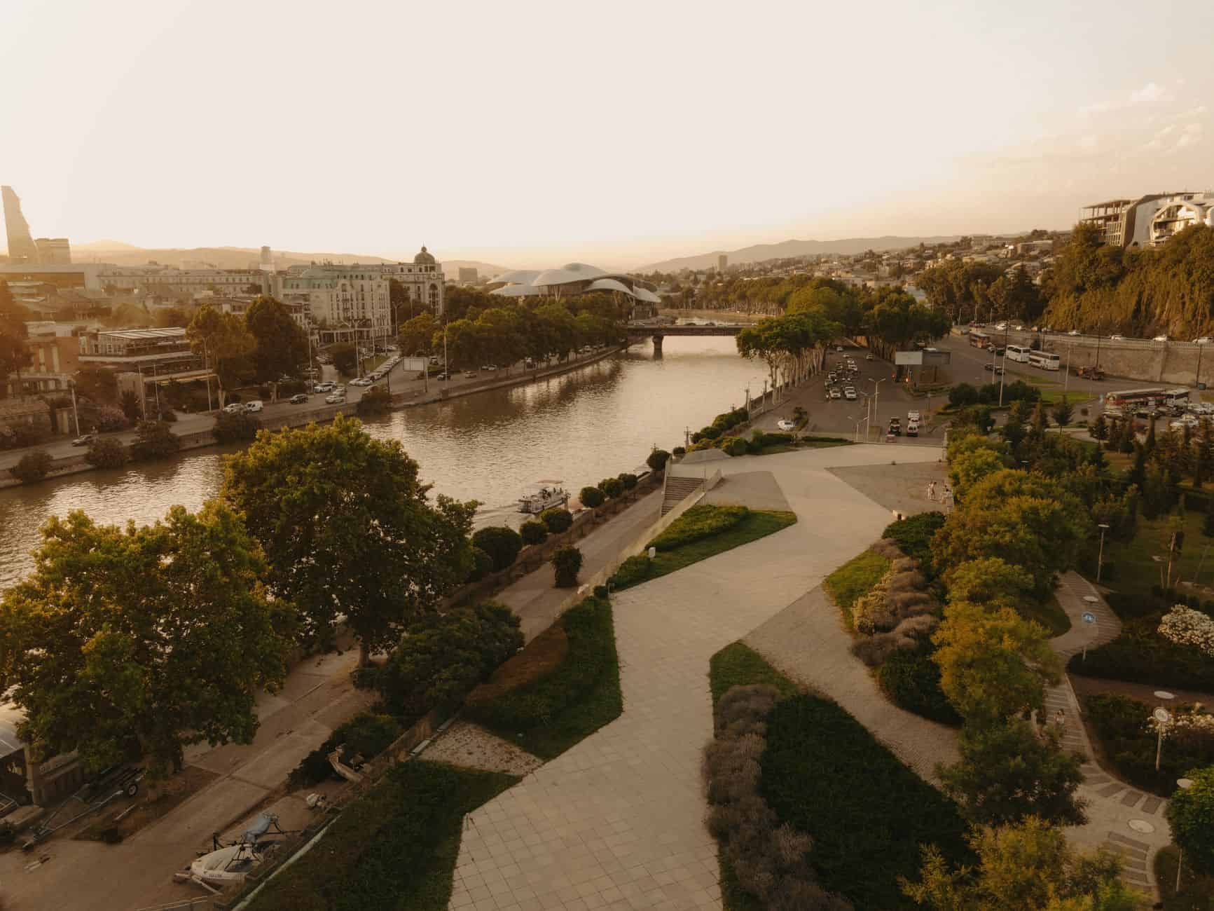 Complete guide to georgia for entrepreneurs showing Tbilisi riverfront and regional cost landscape at sunset