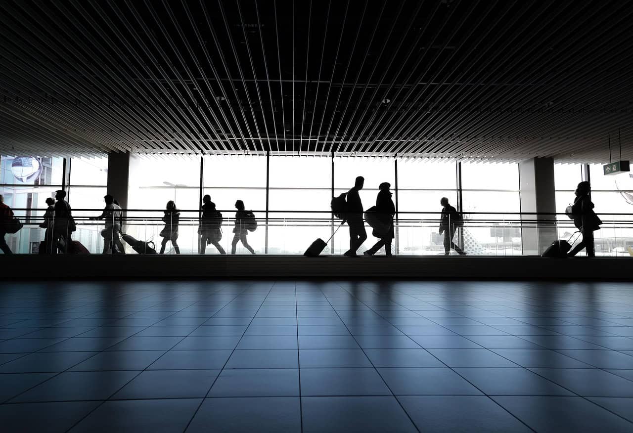 Woman at airport gate facing taxation on unrealized gains when relocating abroad