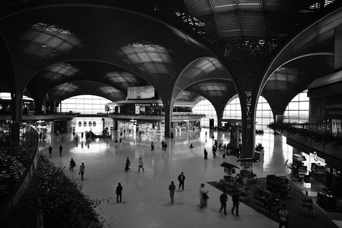 Entrepreneurs leaving France subject to the French exit tax walking through a departure terminal