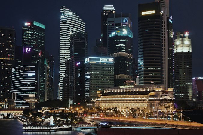 Singapore city skyline at night illustrating digital business fees and GST